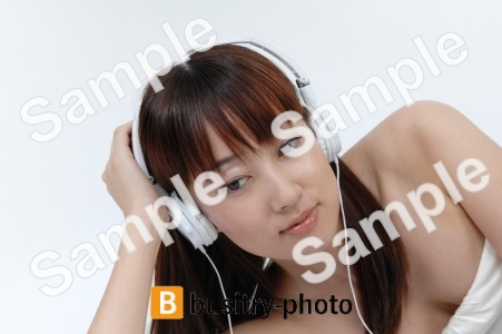 ヘッドホンをつけて音楽を聴く女性